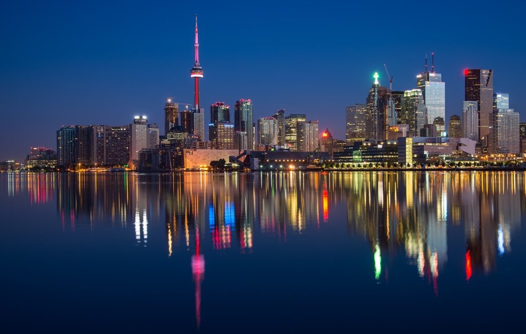 Toronto skyline at night with CN Tower, representing discreet private investigator services in Toronto.