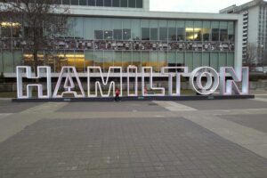 Hamilton City Hall with large block letters, symbolizing FYI Private Investigators' trusted private investigator services in Hamilton and surrounding areas.